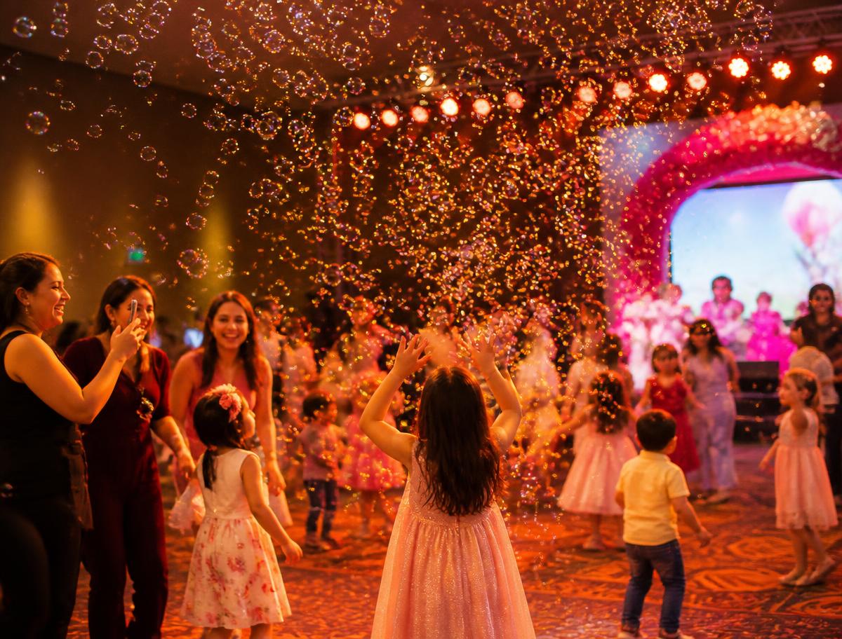Bubble machine filling a party hall with floating bubbles